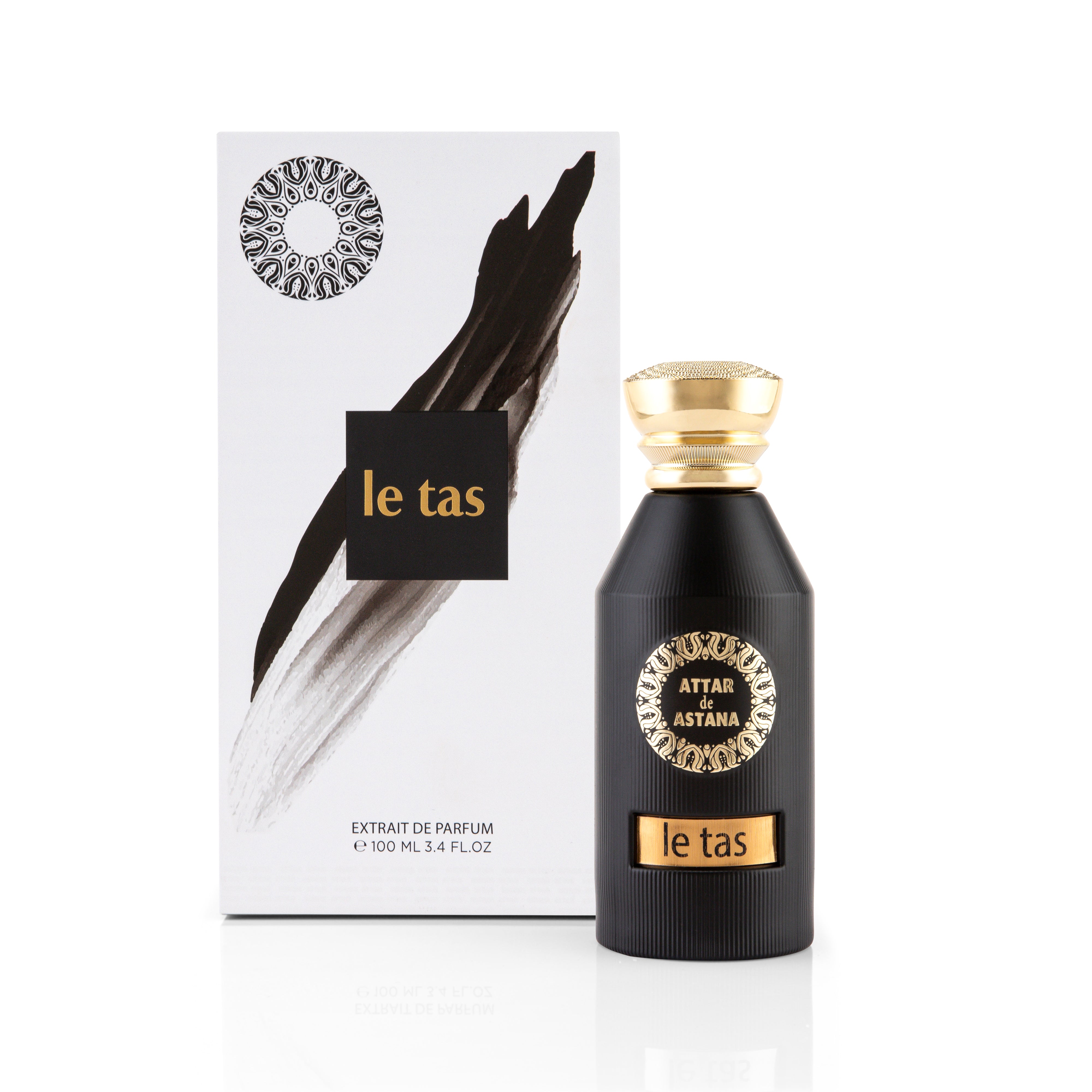 Le Tas 100 ML Extrait De Parfum by Attar de Astana Black perfume bottle with gold accents and 'le tas' branding next to its packaging on a white background.
