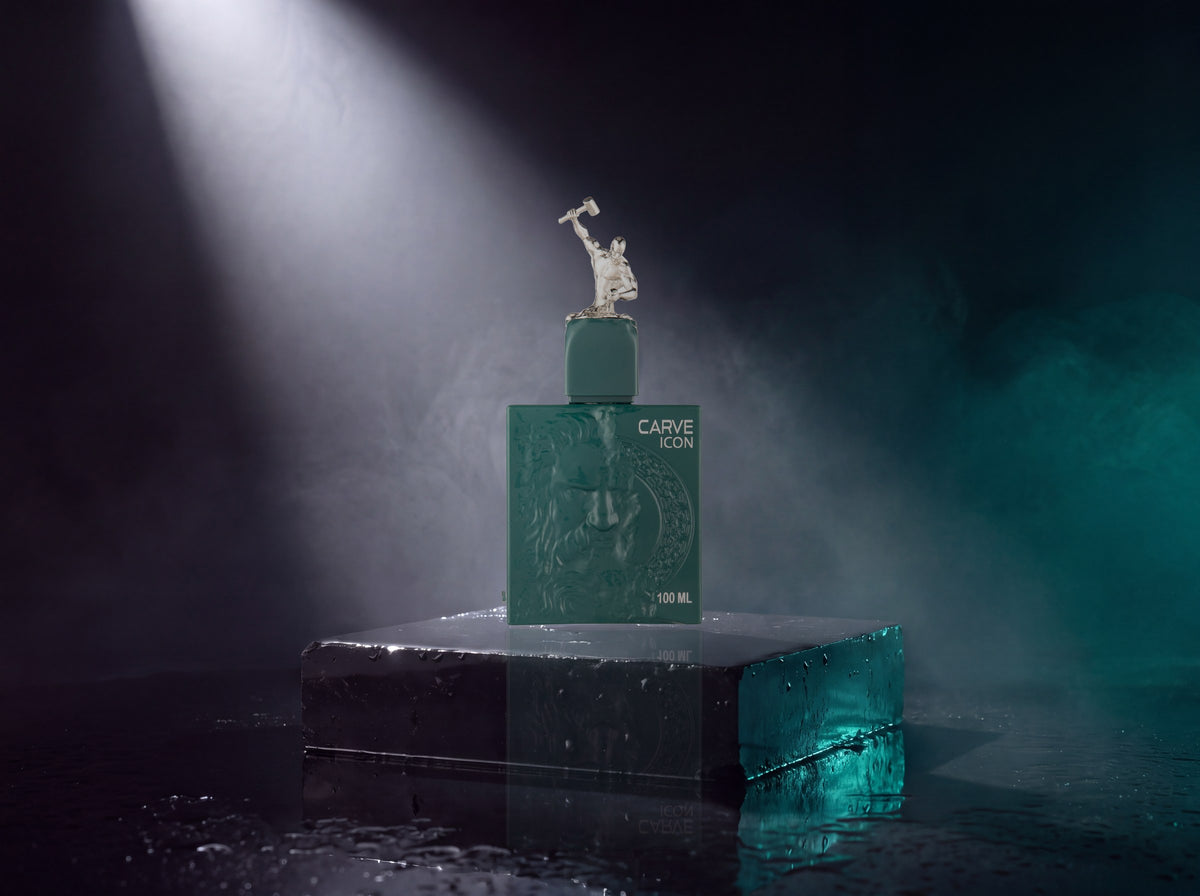 The Carve Icon bottle standing on a block of polished black basalt under a hard white spotlight, teal haze and a wet floor around it