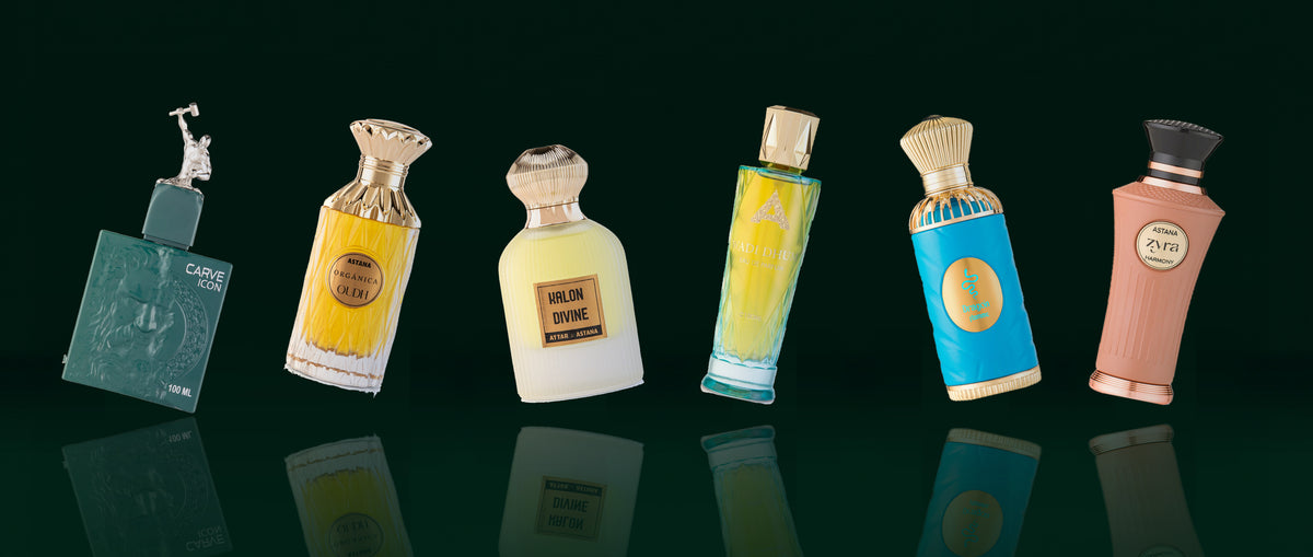 Six Attar de Astana bottles floating in a row above a dark green mirror floor, each tilted a little: Carve Icon, Organica Oudh, Kalon Divine, Wadi Dhum, Dragon Flame and Zyra Harmony
